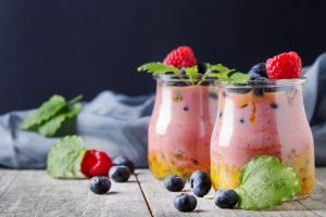 Fresh,homemade,yogurt,in,a,glass,jar,with,blueberries,,raspberries,