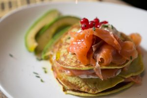 Closeup,of,salmon,on,a,green,pancakes,with,fresh,cream