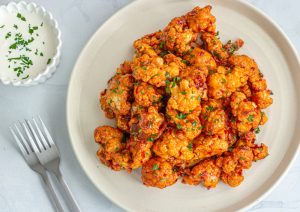 Barbecue,cauliflower,wings,on,a,white,plate.,buffalo,cauliflower,bites